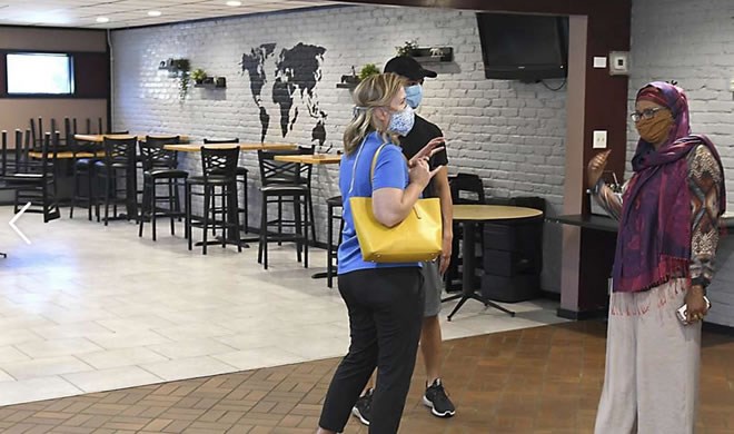 Nasra "Jamila" Ibrahim, right, owner of J's Sambusa in North Mankato, Minn. greets customers Sue and Alex Liebl, of Mankato, on the business' opening day Monday, July 27, 2020. Before Nasra “Jamila” Ibrahim emigrated to the United States from Somalia in 1994, she worked at her brother’s restaurant in Mogadishu.