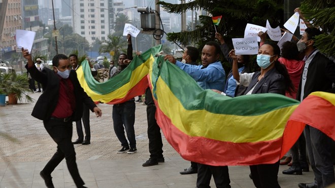 Ethiopians celebrate the progress made on the Nile dam, in Addis Ababa, Ethiopia, Sunday Aug. 2, 2020. Ethiopians in the capital celebrated the progress in the construction of the country’s dam on the Nile River, which has caused regional controversy over its filling. In joyful demonstrations urged by posts on social media and apparently endorsed by the government, tens of thousands of residents flooded the streets of the capital Addis Ababa on Sunday afternoon, waving Ethiopia’s flag and holding up posters. (AP Photo/Samuel Habtab)