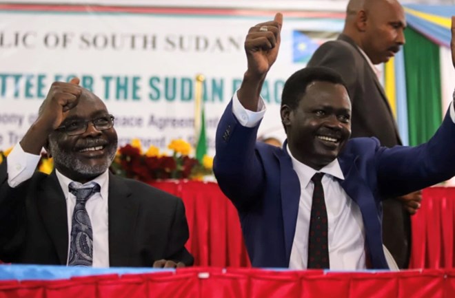 Rebels leaders gesture after the signing of the peace agreement [Samir Bol/Reuters]