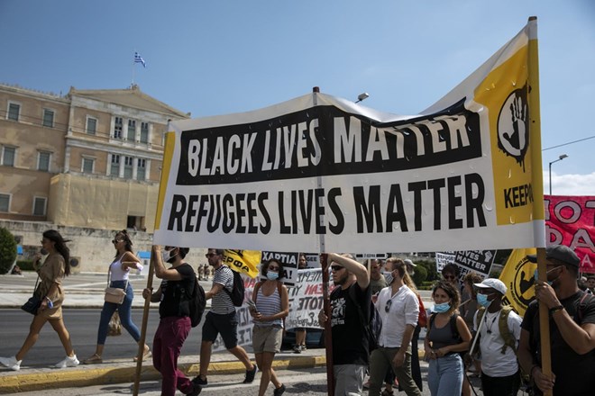 Protesters march in front of the parliament during a rally in support of the migrants on the island of Lesbos, in Athens, Saturday, Sep. 12, 2020. Thousands of asylum-seekers spent a fourth night sleeping in the open on the Greek island of Lesbos, after successive fires destroyed the notoriously overcrowded Moria camp during a coronavirus lockdown.(AP Photo/Yorgos Karahalis)